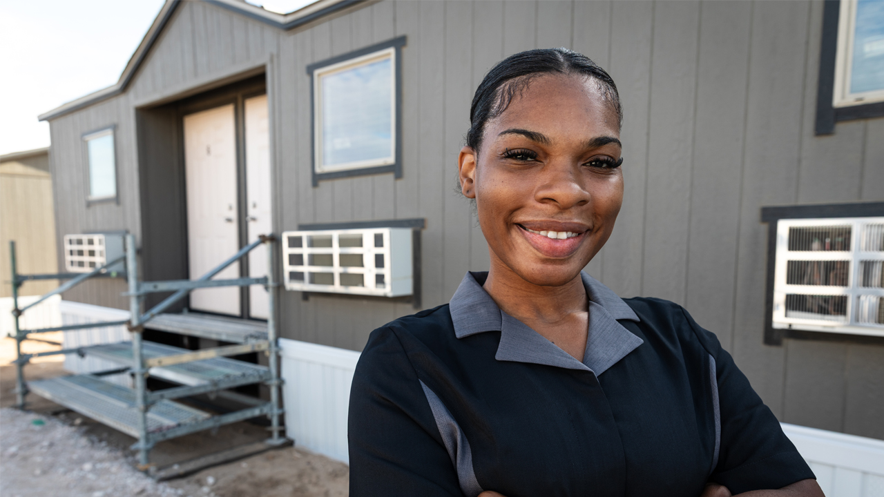 Woman standing in front of a building.